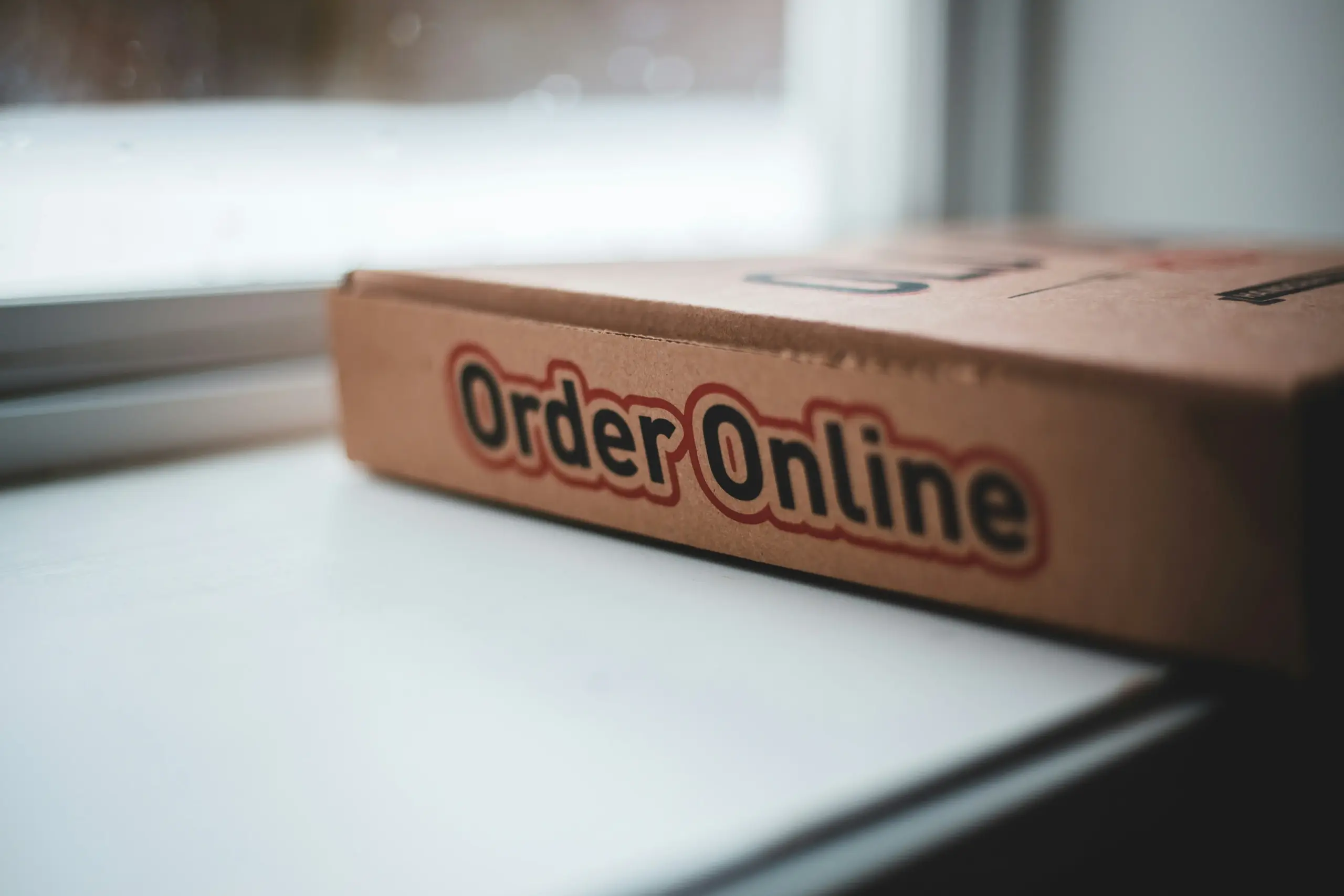 Meal prep website asking customers to enter a postcode before menu selection, showing delivery availability, valid delivery days, cut-off, and pickup options.